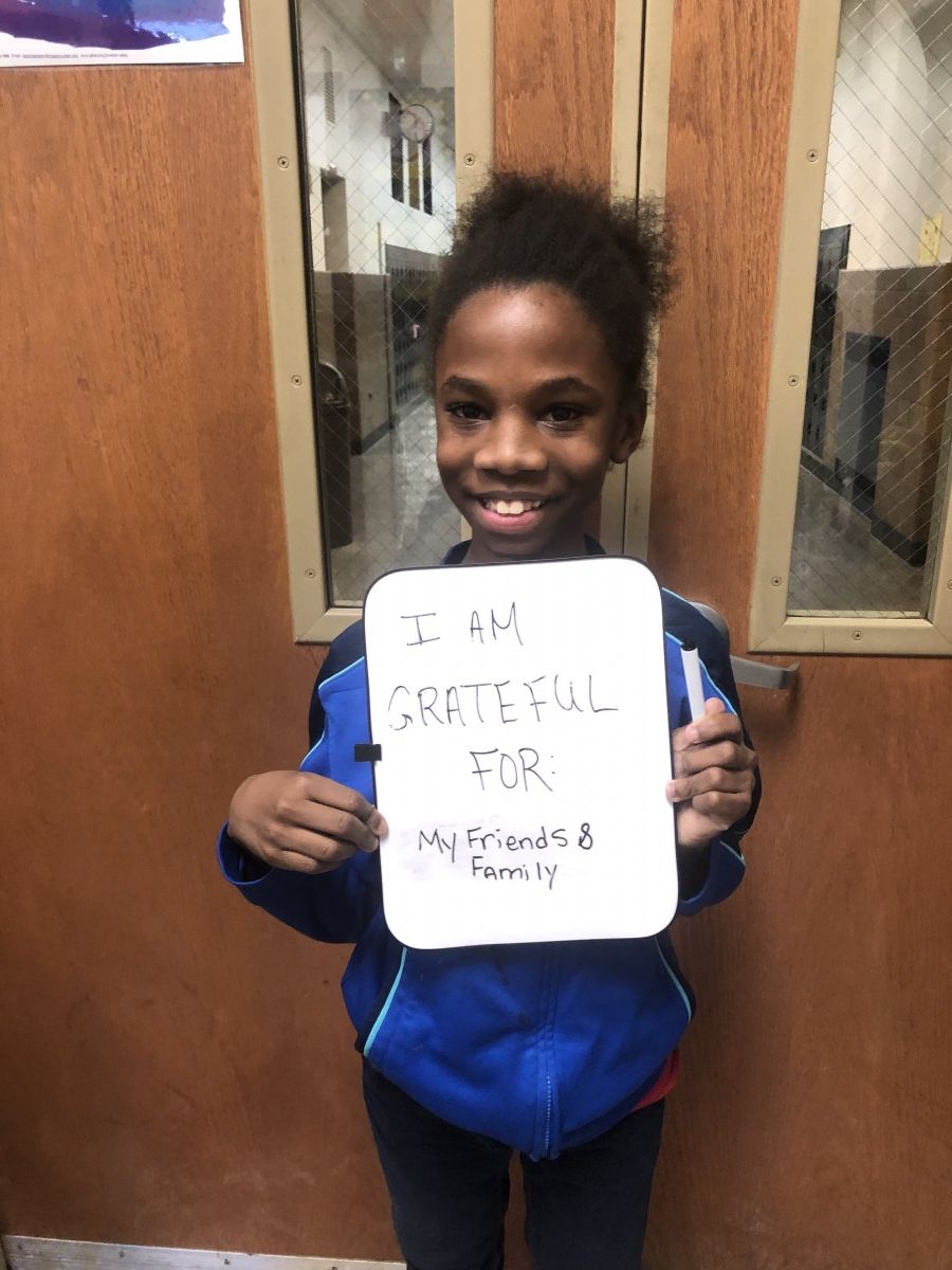 Student holding message of thanks.