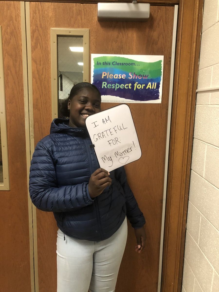 Student holding message of thanks.