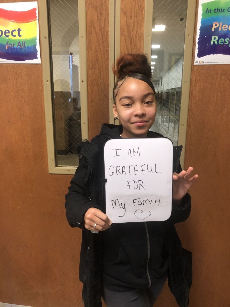 Student holding message of thanks.