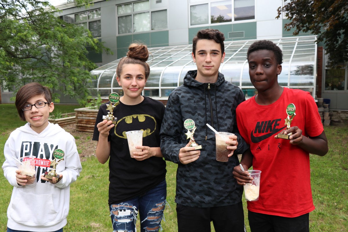 The students gather for a photo with their trophies.