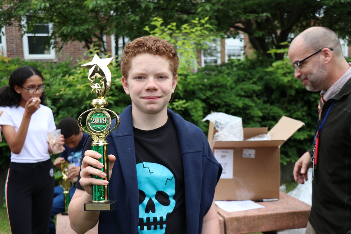 A student poses with his trophy.