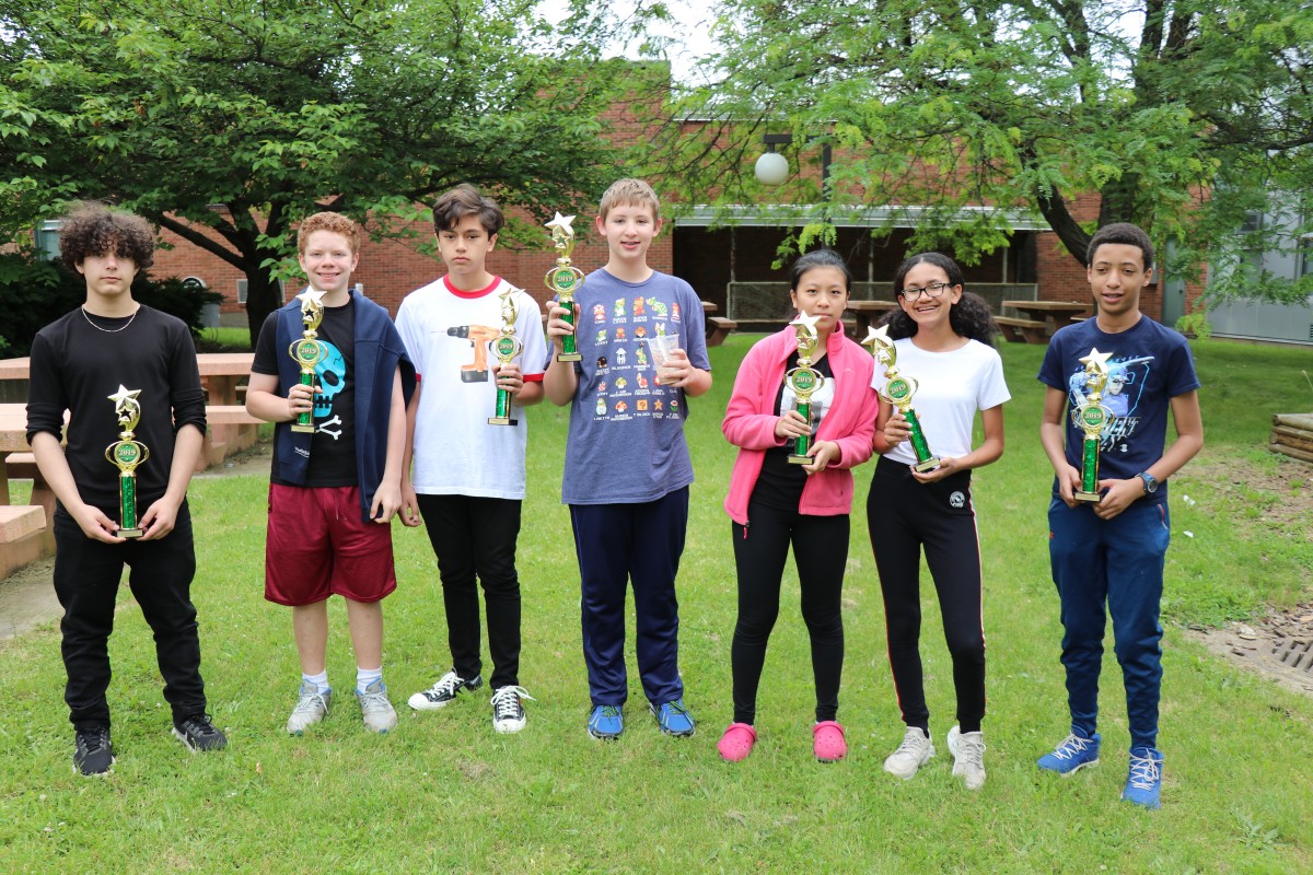 The students gather for a photo with their trophies.