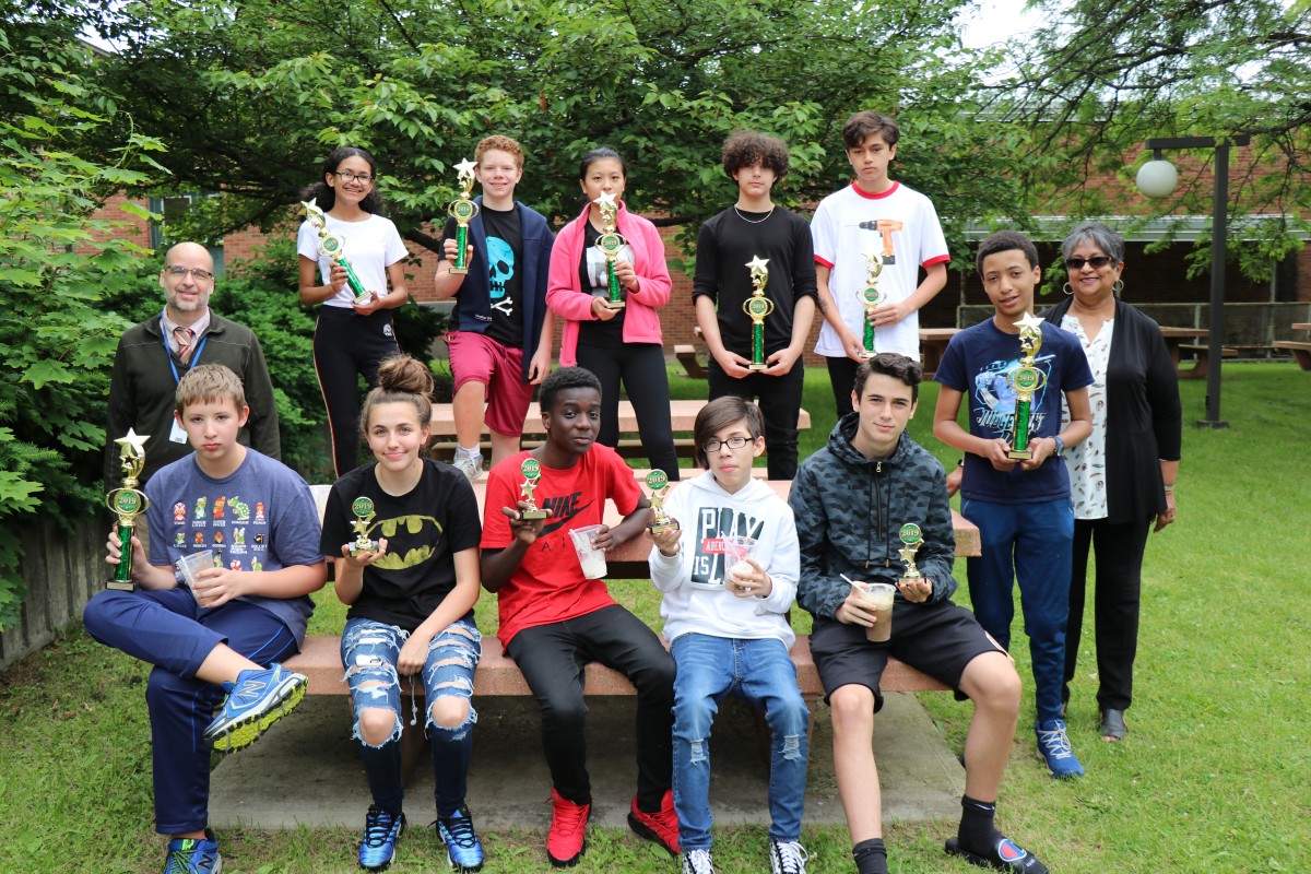 The students gather for a photo with their trophies.