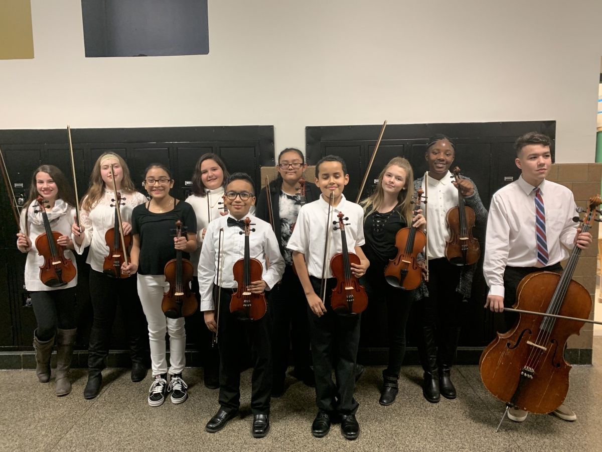 Students pose for a photo with their instruments.