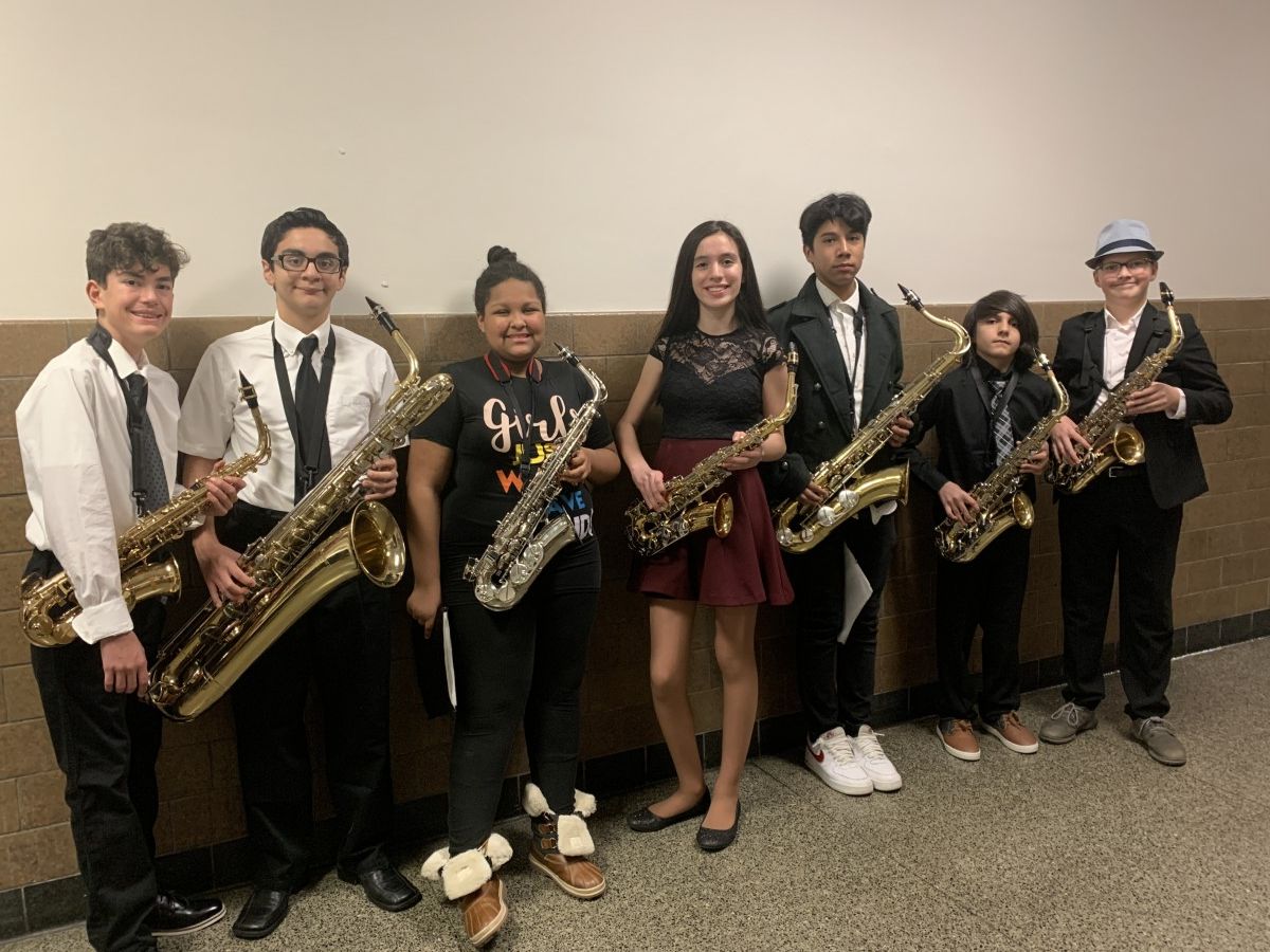 Students pose for a photo with their instruments.