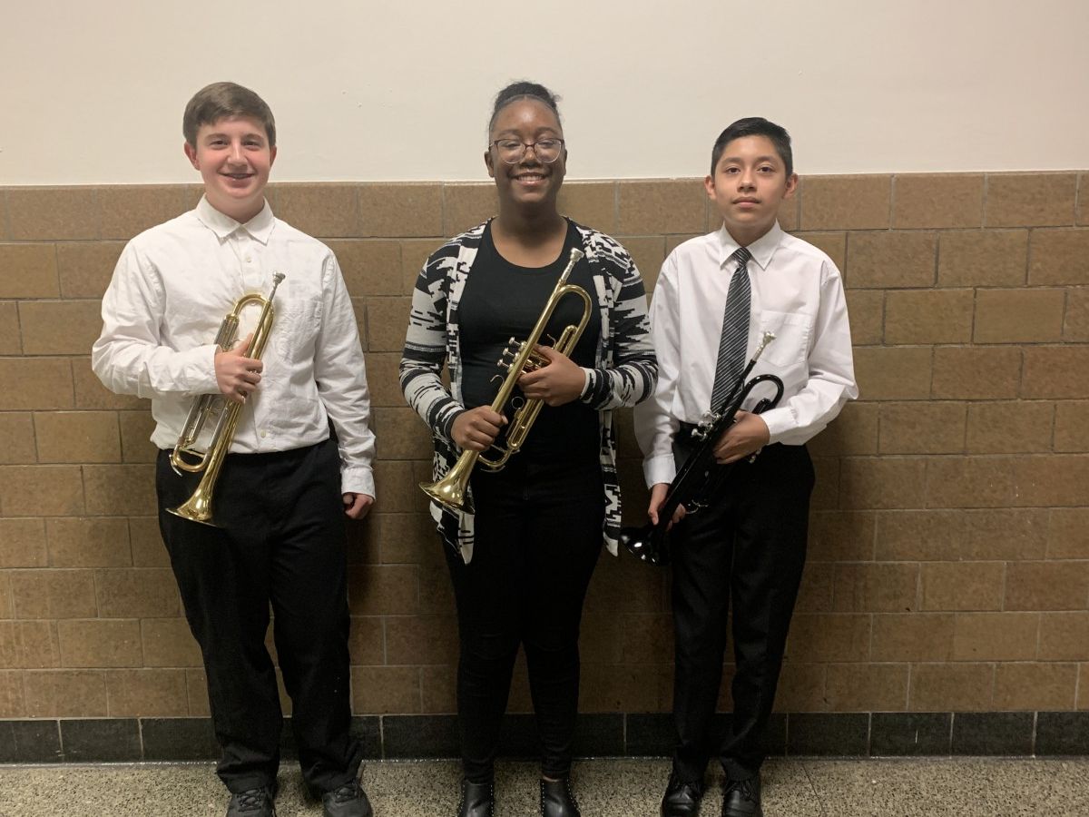 Students pose for a photo with their instruments.