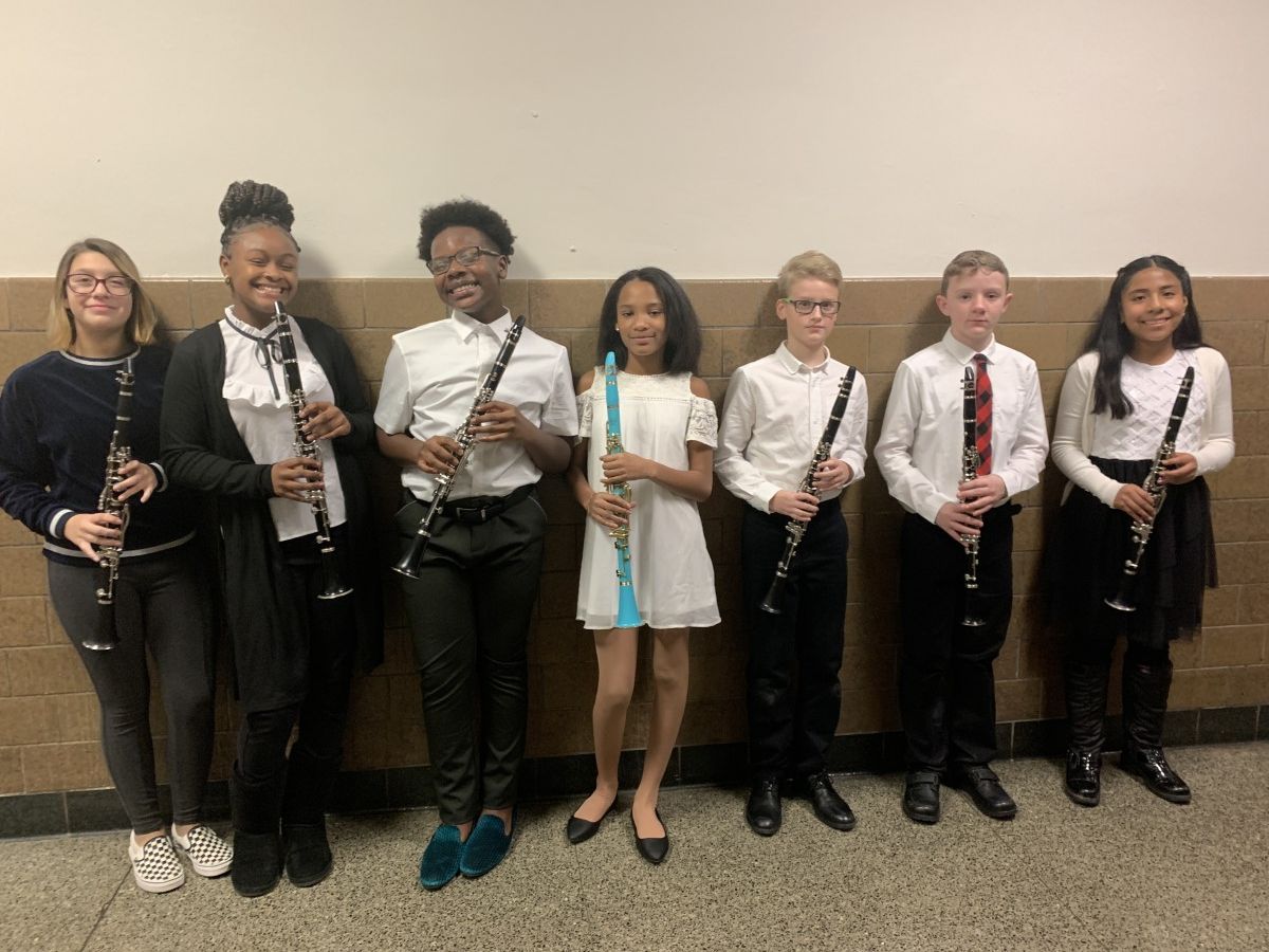 Students pose for a photo with their instruments.