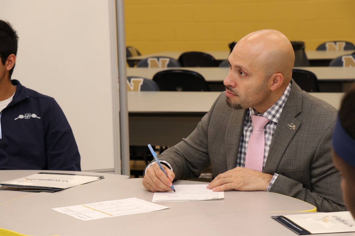 Dr. Padilla listens to scholars and takes notes.