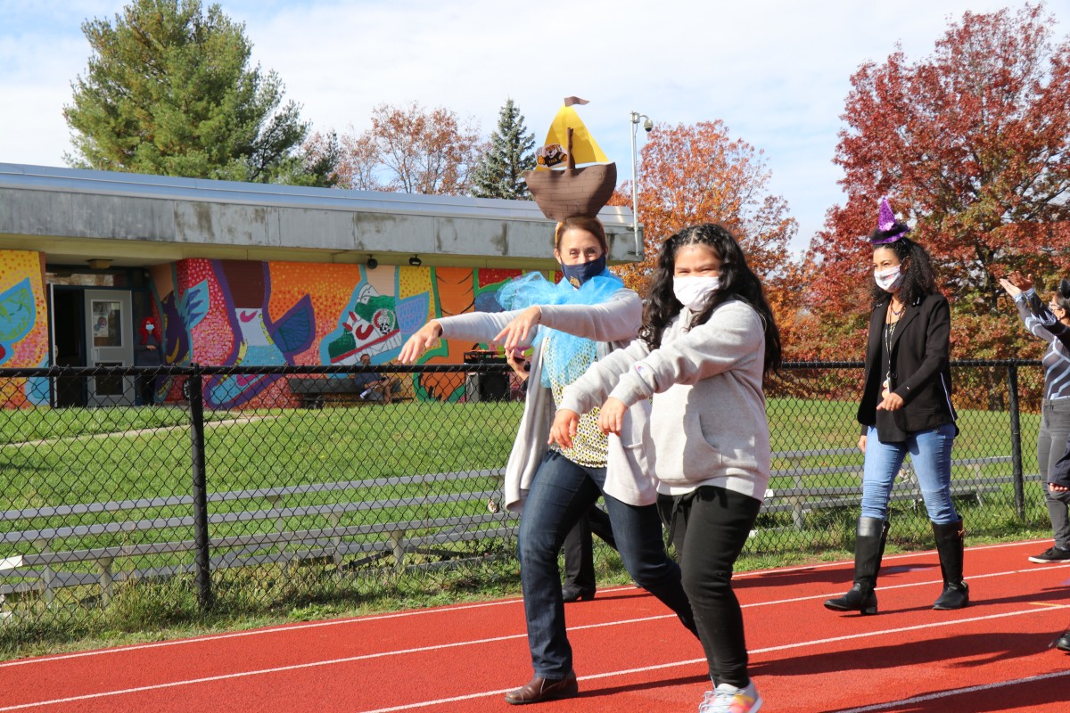 Student wears costume and marches in parade.