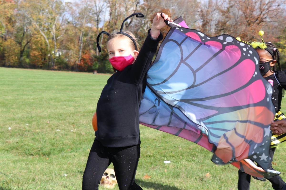 Student wears costume and marches in parade.