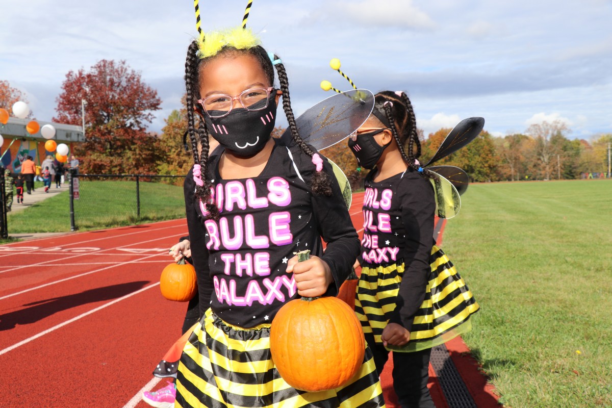 Student wears costume and marches in parade.