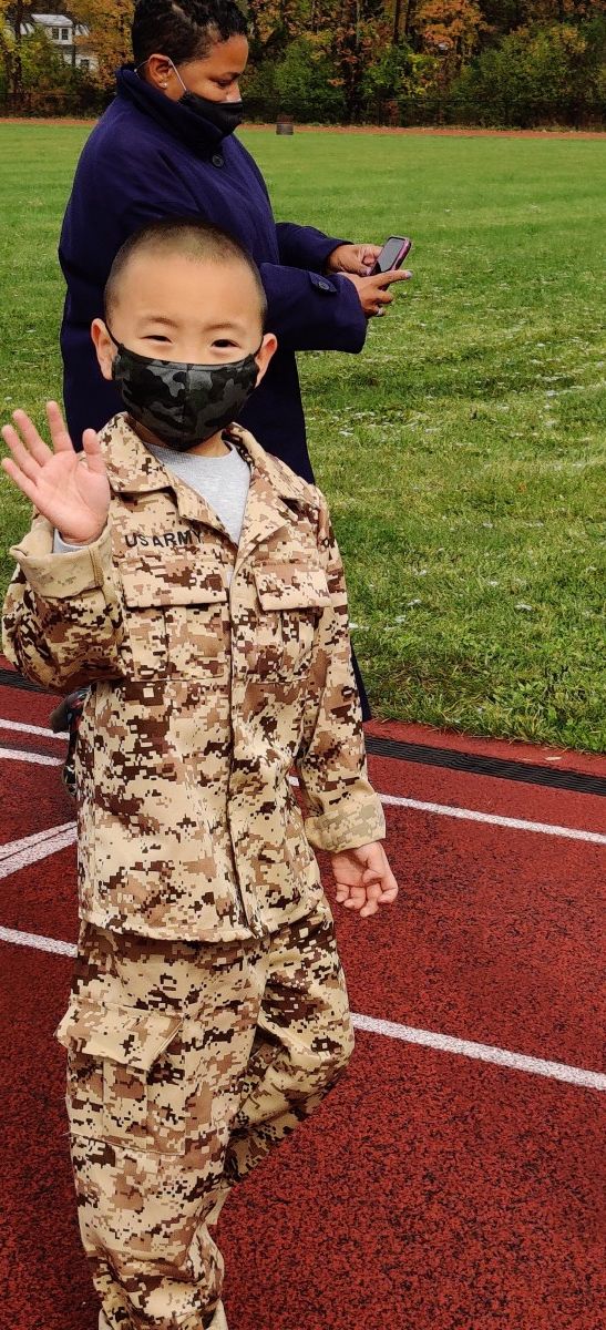 Student wears costume and marches in parade.