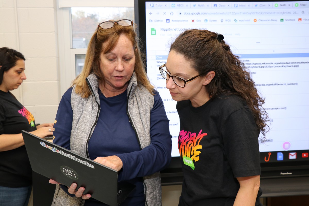 Ms. Merrill discussing a lesson with Mrs. Zoutis, ITF at GAMS and Vails Gate.