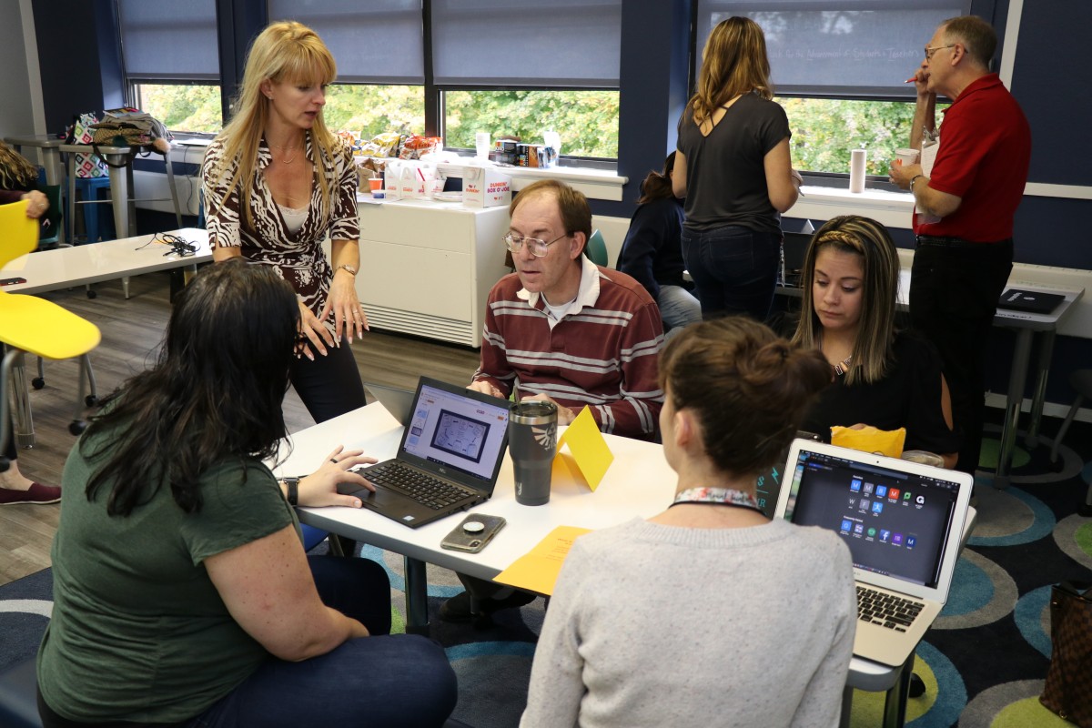 Teachers engage in professional development exercises.