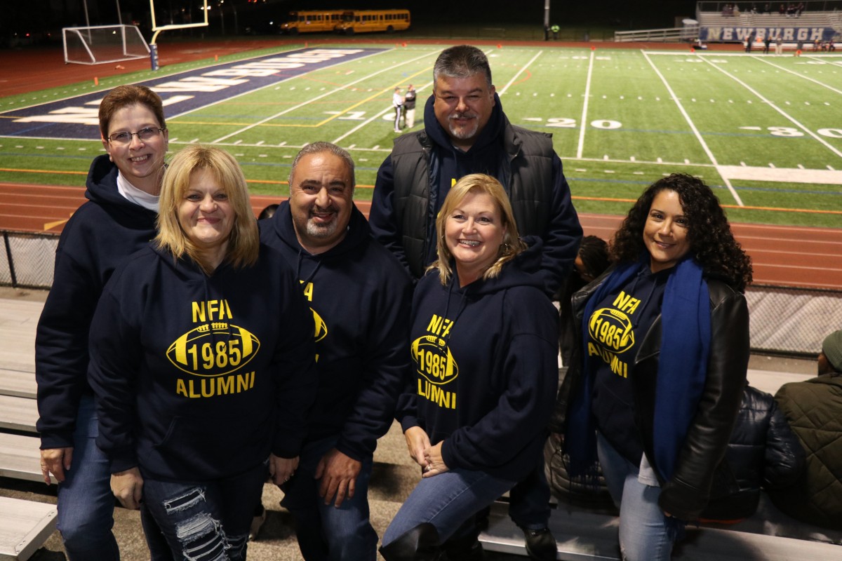 Members of the class of 1985 pose with their sweatshirts.