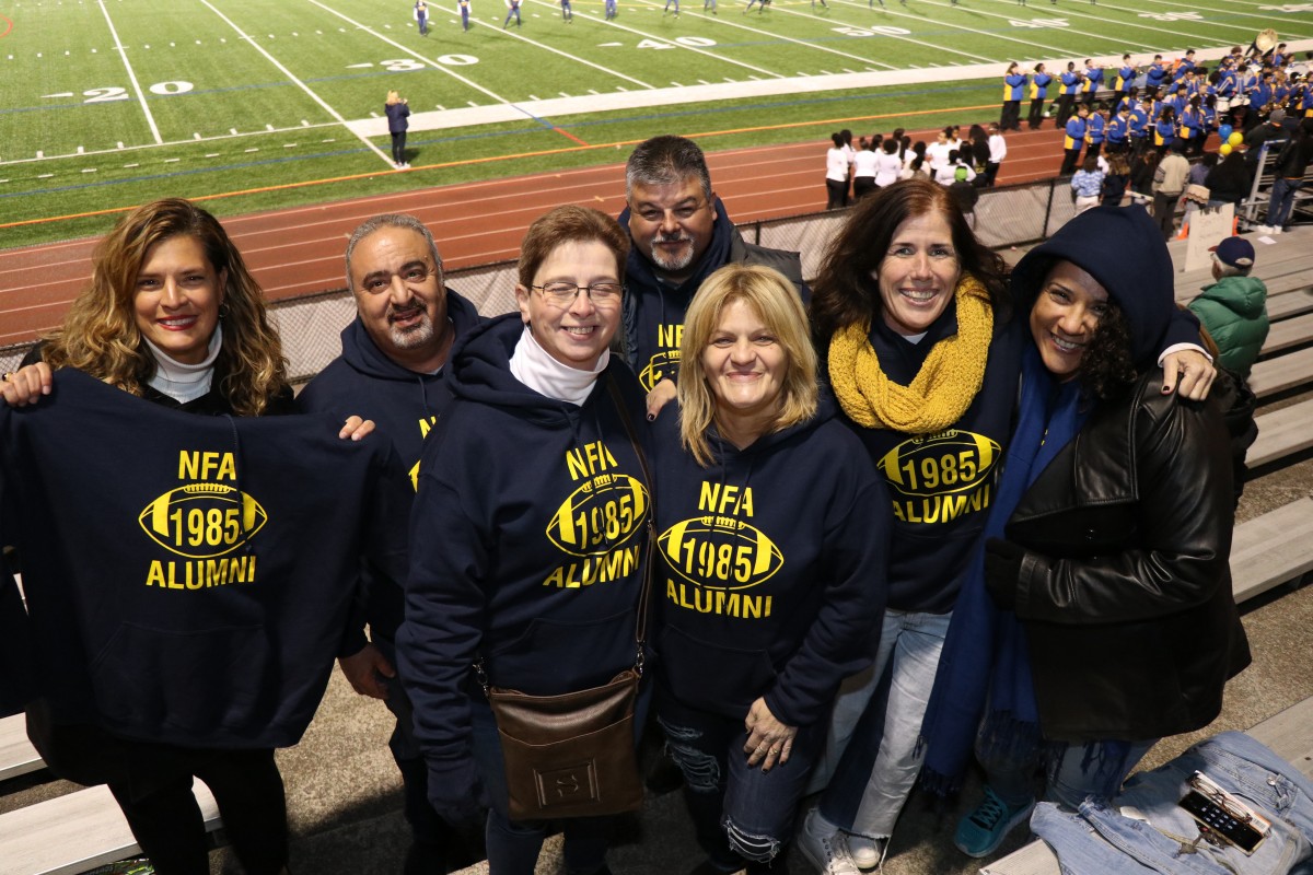 Members of the class of 1985 pose with their sweatshirts.