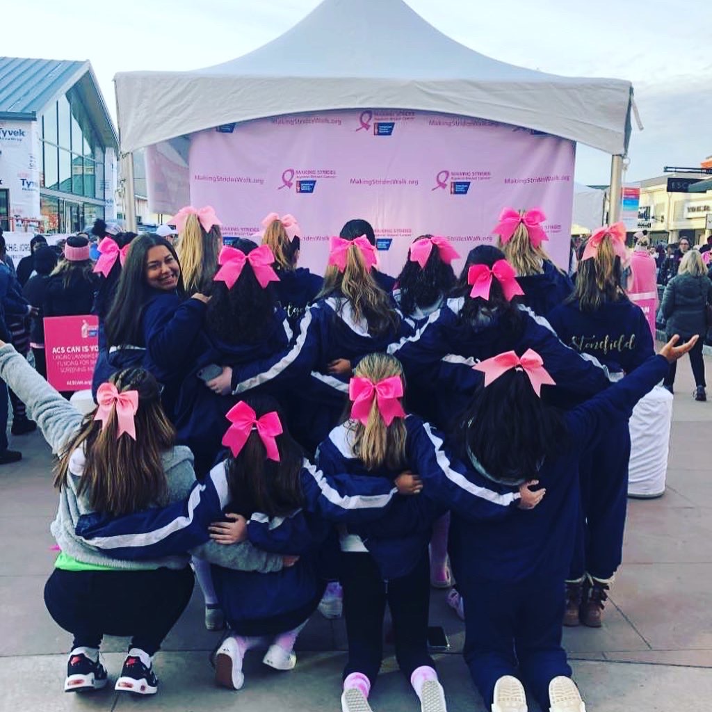 NFA cheerleaders show off their pink bows at the Walk to End Breast Cancer.