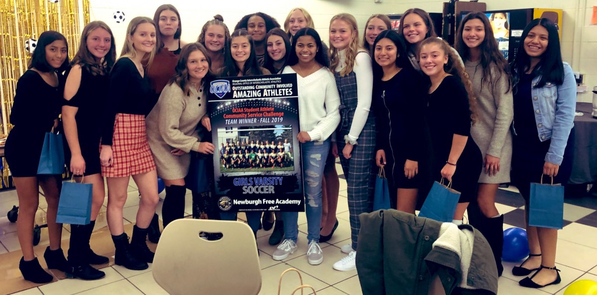 NFA Varsity Girls Soccer team and coaches pose for a photo.