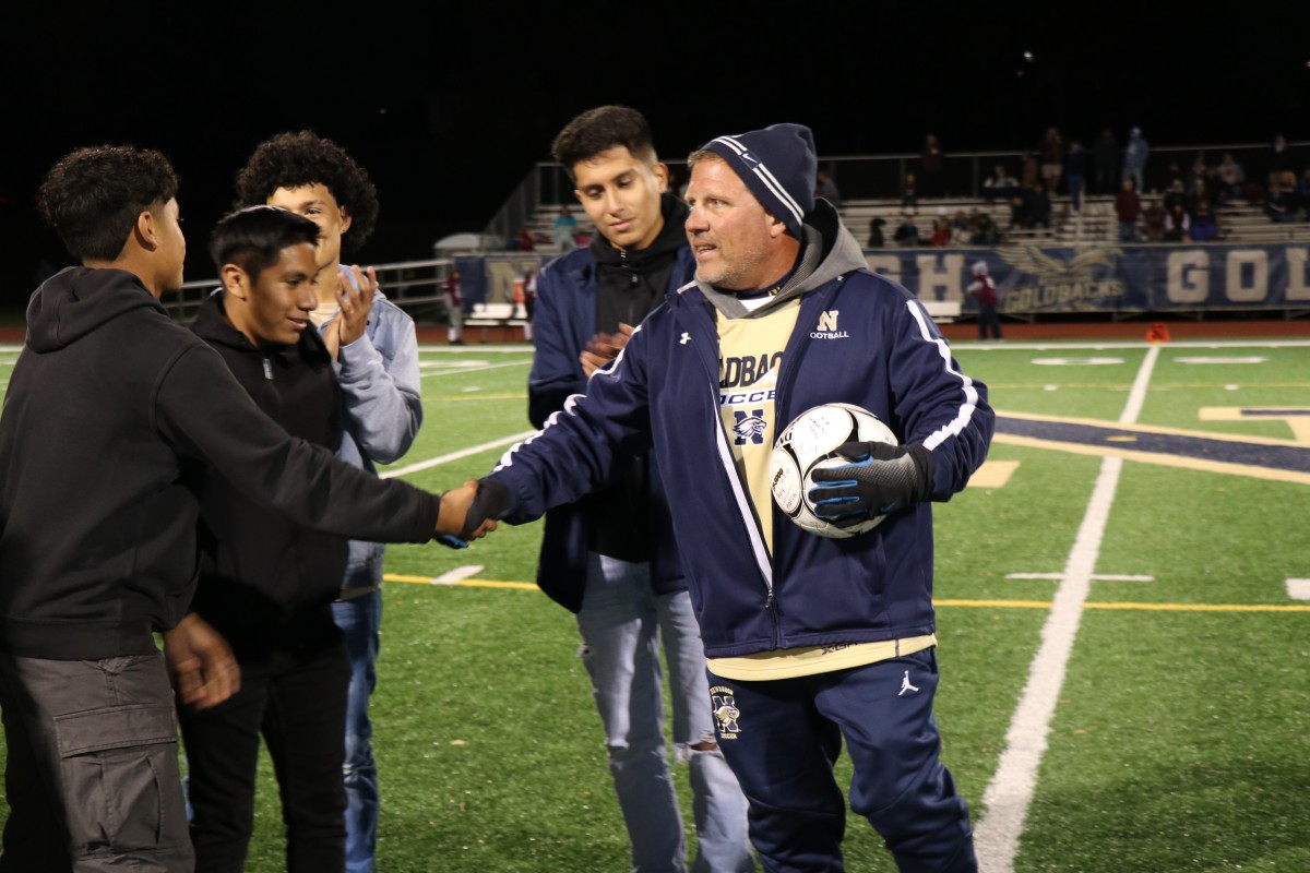 Coaches Iorlano shakes hands with a player.