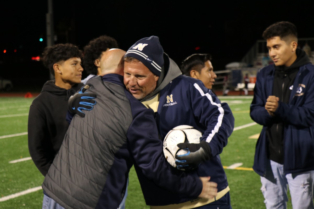 Coach Iorlano receives a congratulatory hug.