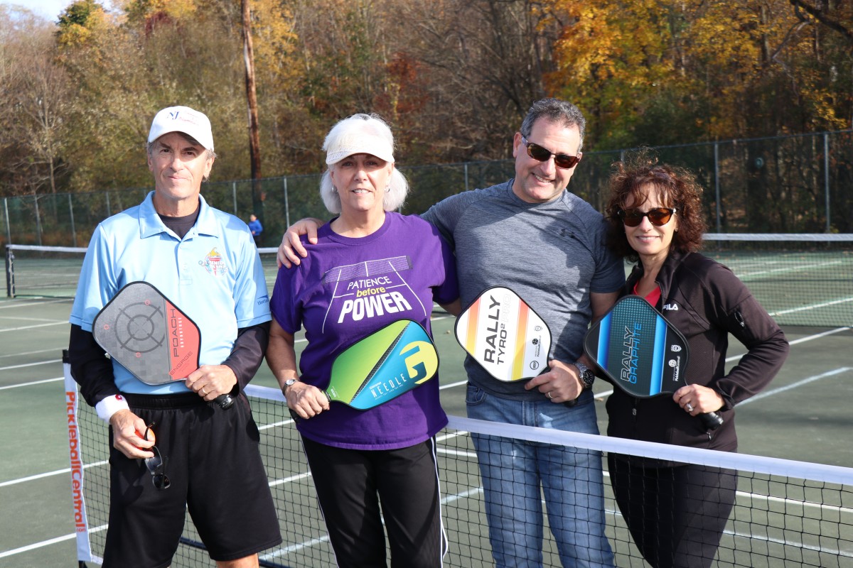 Pickleball players pose for a photo.