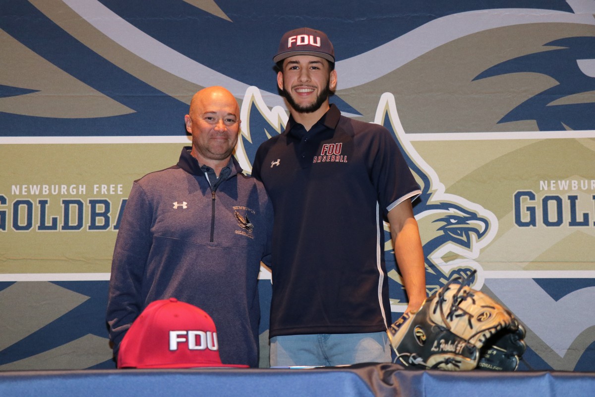 Lucas and athletic director, Mr. Edgar Glascott pose for a photo.