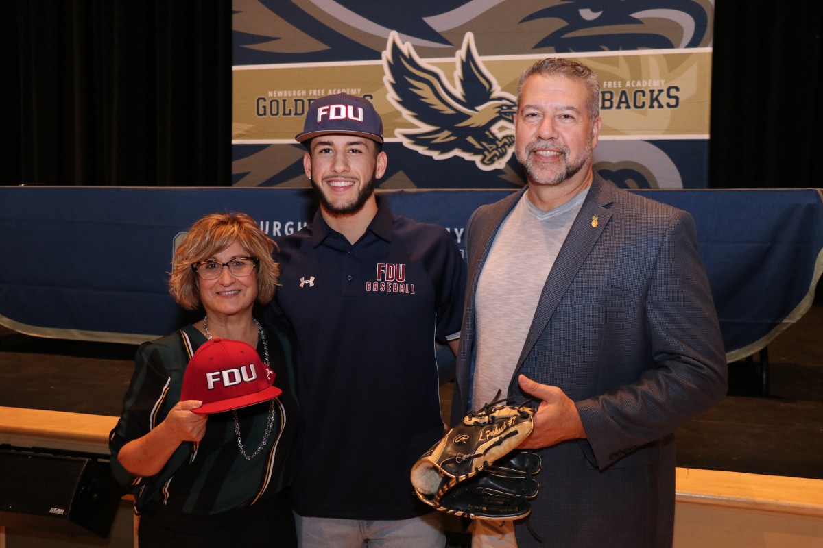 Lucas poses for a photo with his parents.