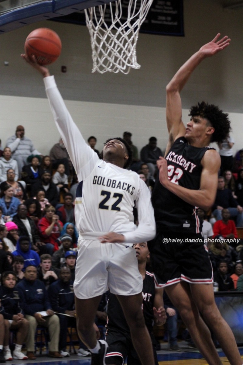 Ernest Elliot goes up for a shot against Andre Jackson from Albany Academy.