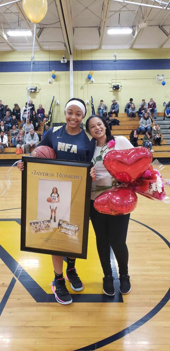 NFA Girls Varsity Basketball senior poses for a photo with her family.
