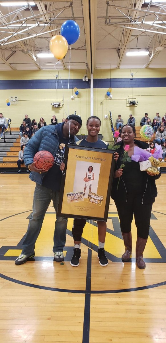 NFA Girls Varsity Basketball senior poses for a photo with her family.