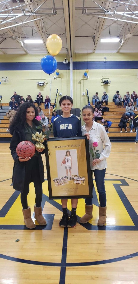 NFA Girls Varsity Basketball senior poses for a photo with her family.