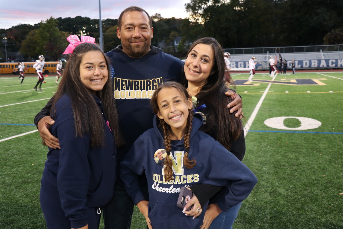 Athlete and family members pose for a photo.