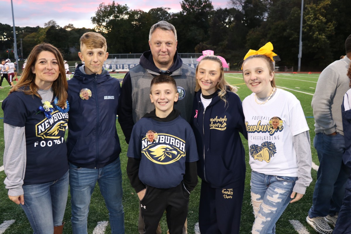 Athlete and family members pose for a photo.