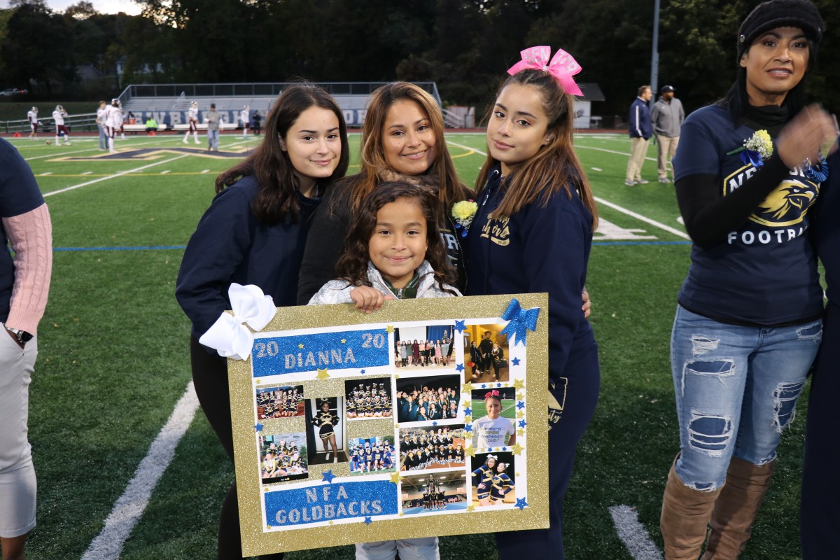 Athlete and family members pose for a photo.