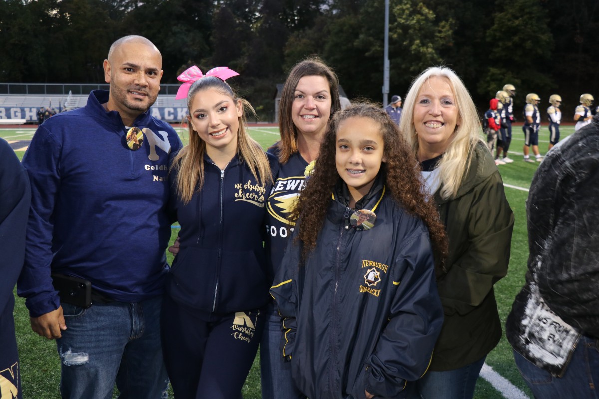 Athlete and family members pose for a photo.