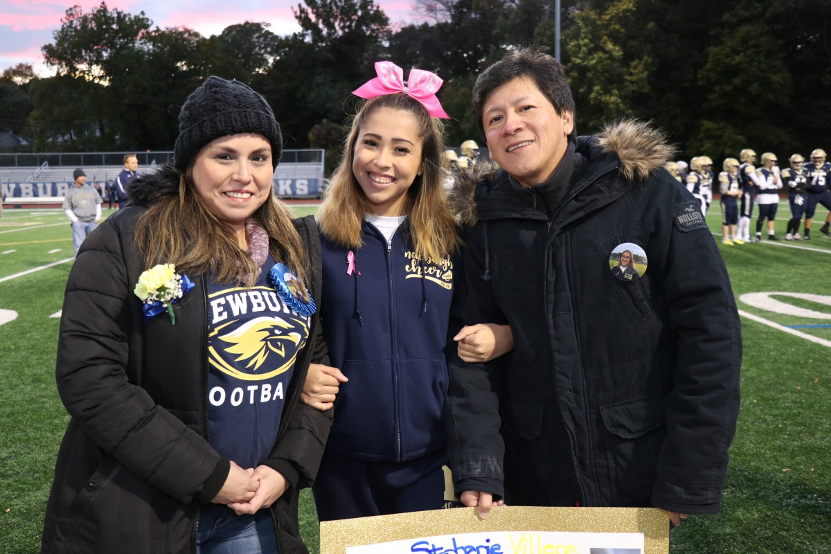 Athlete and family members pose for a photo.