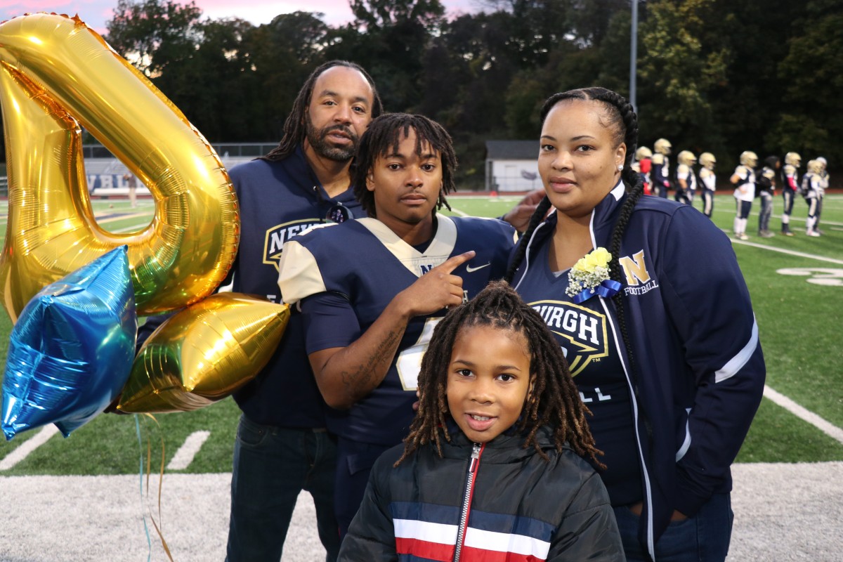 Athlete and family members pose for a photo.