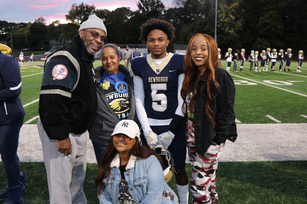 Athlete and family members pose for a photo.