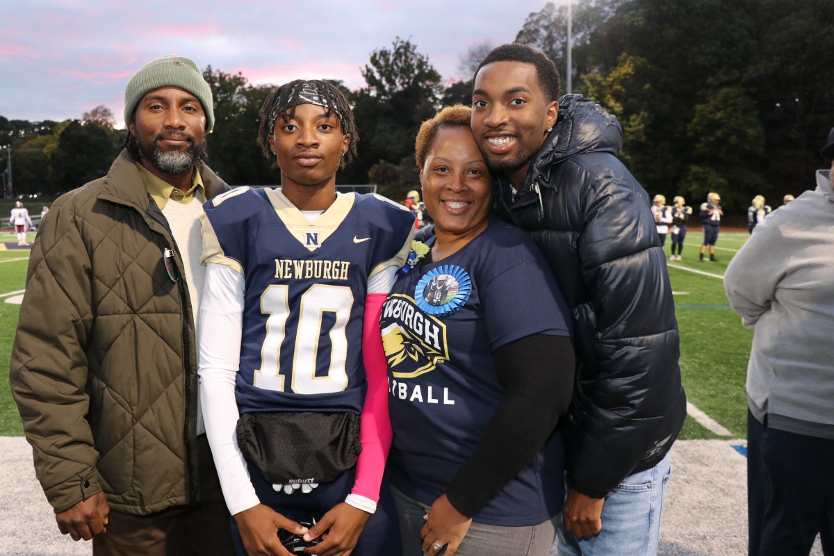 Athlete and family members pose for a photo.