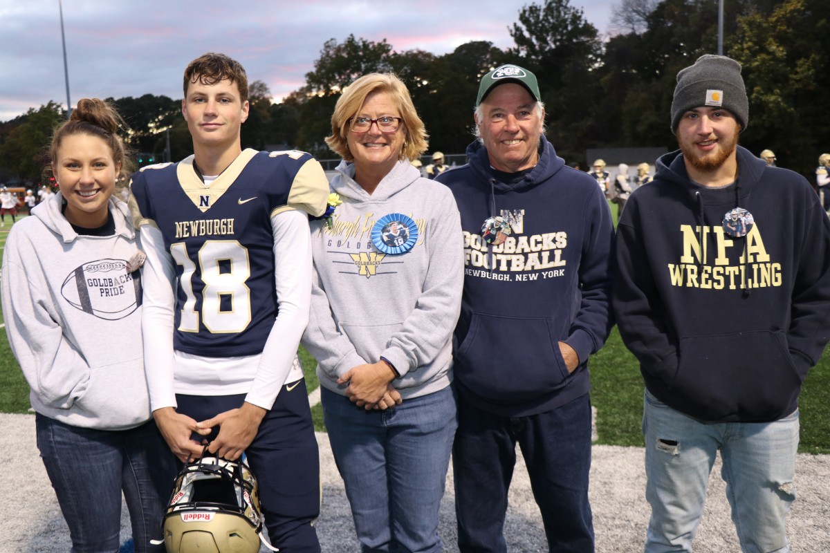 Athlete and family members pose for a photo.