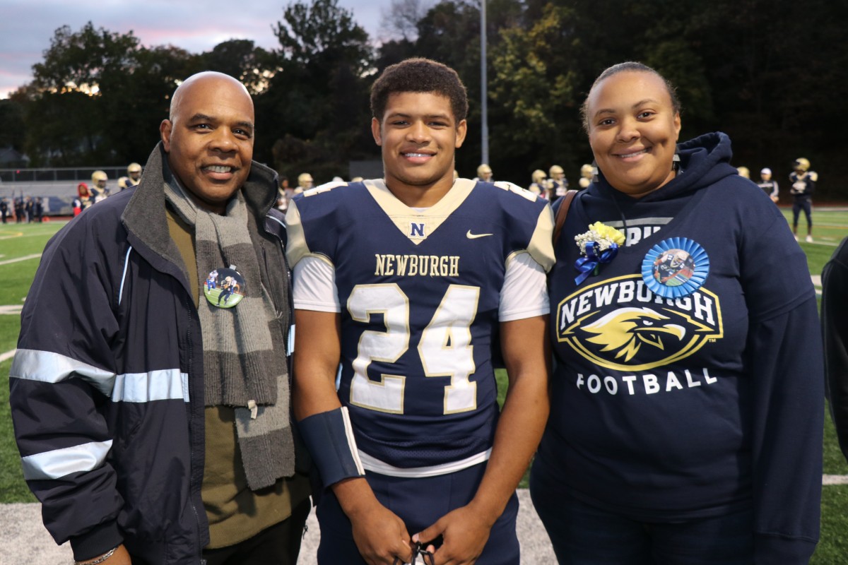 Athlete and family members pose for a photo.