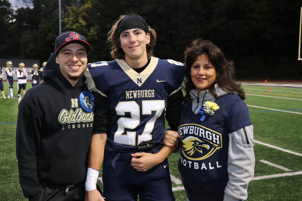 Athlete and family members pose for a photo.