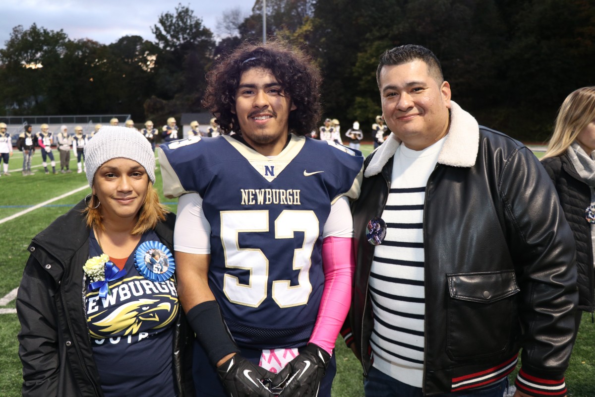 Athlete and family members pose for a photo.