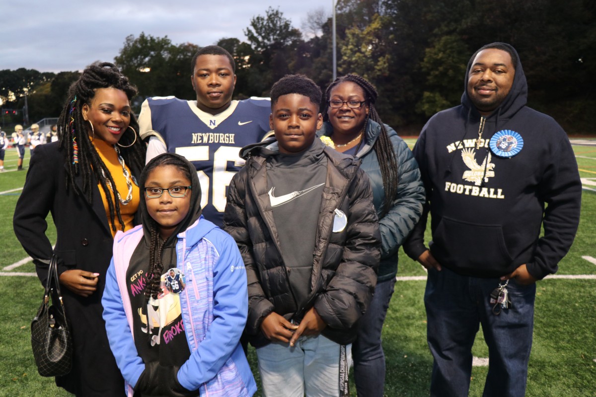 Athlete and family members pose for a photo.