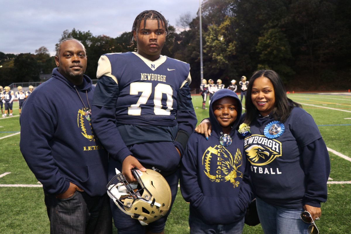 Athlete and family members pose for a photo.