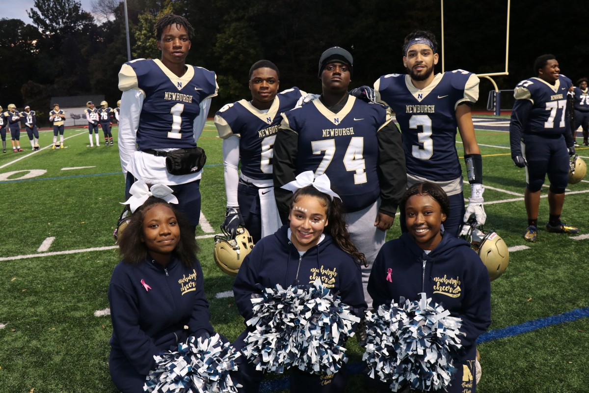 Athletes pose for a photo.