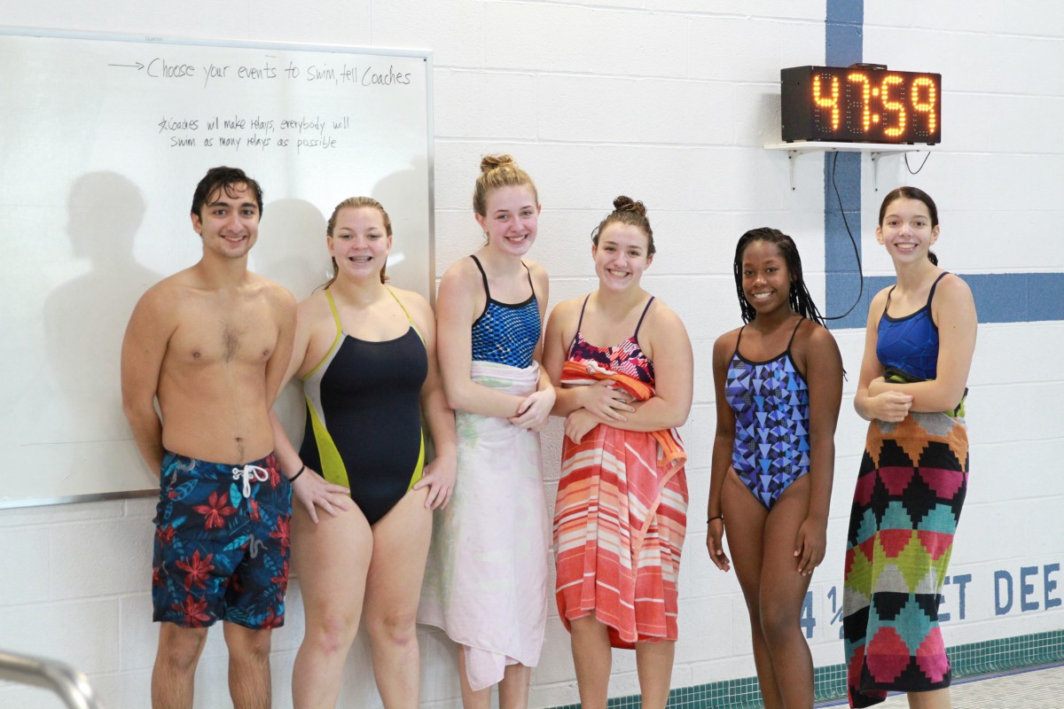 Athletes pose for a photo.