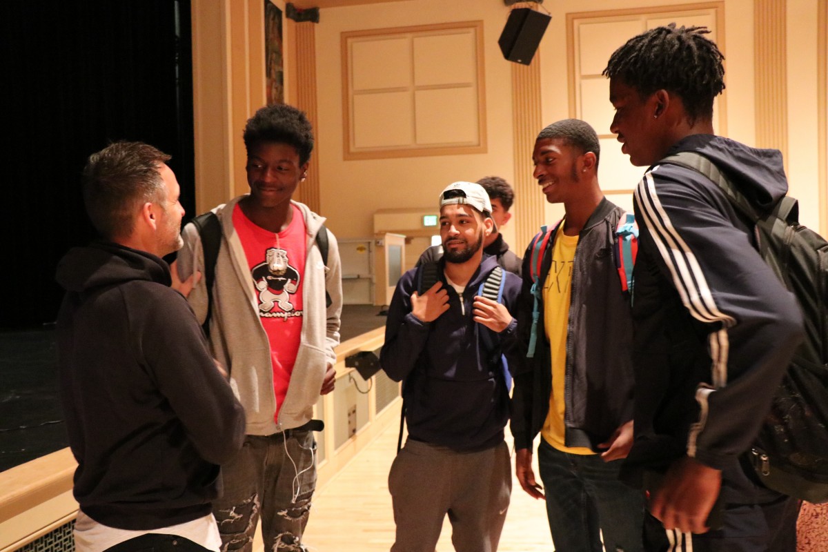 Students speak with the presenter after the program.