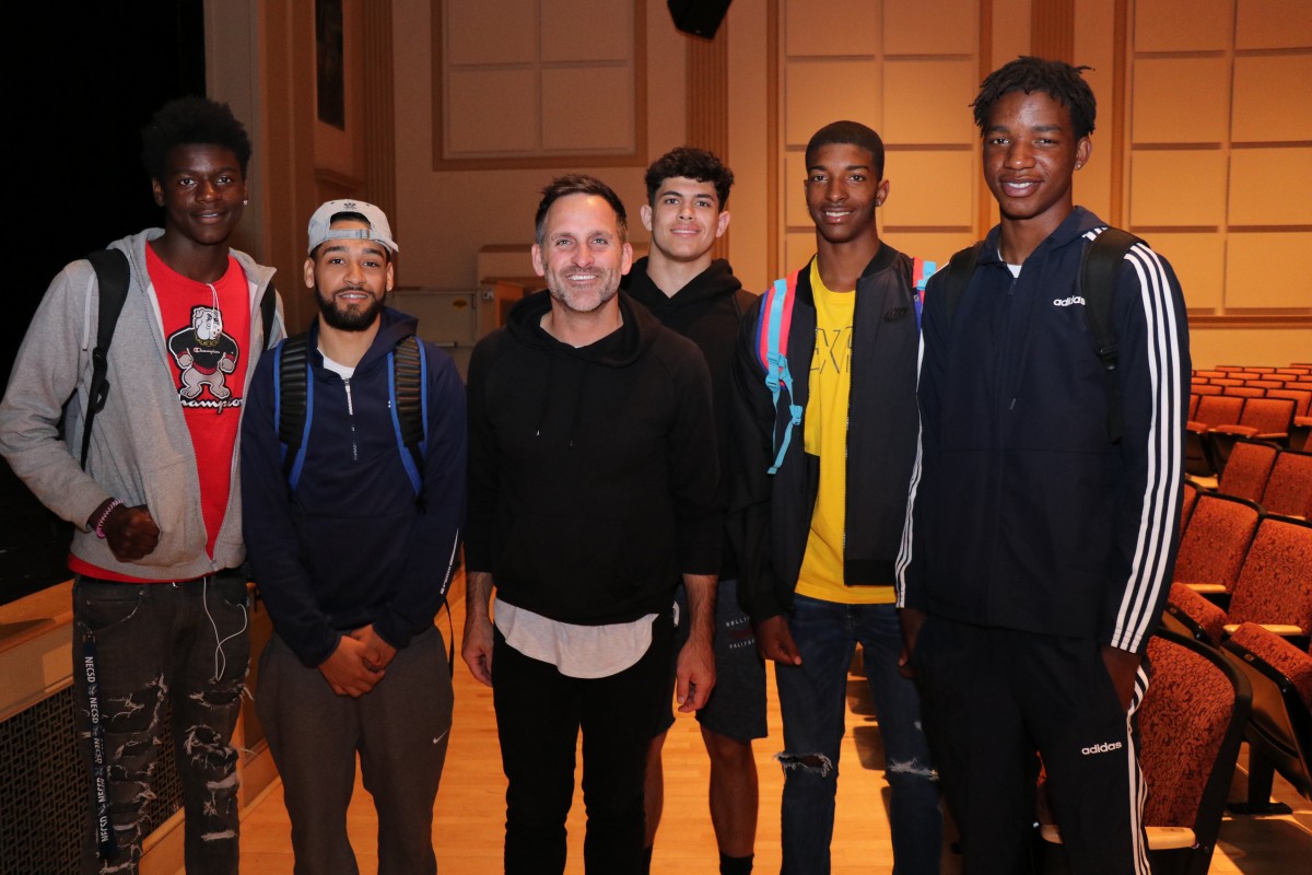 Student athletes pose for a photo with the presenter.