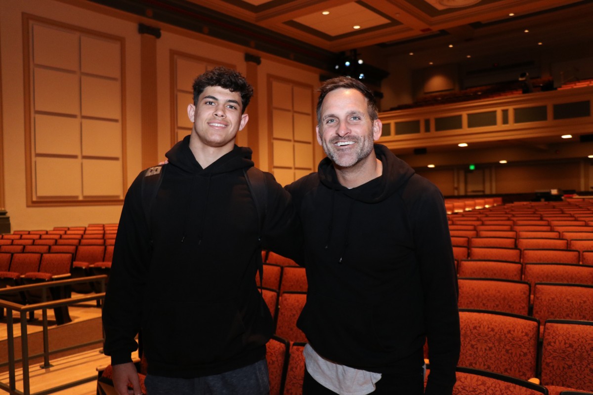 Student and presenter pose for a photo.